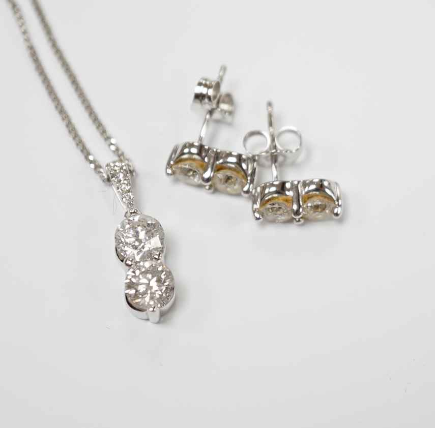 A modern 14k gold and two stone diamond set pendant, with diamond chip set bale, on a 14k gold fine link chain